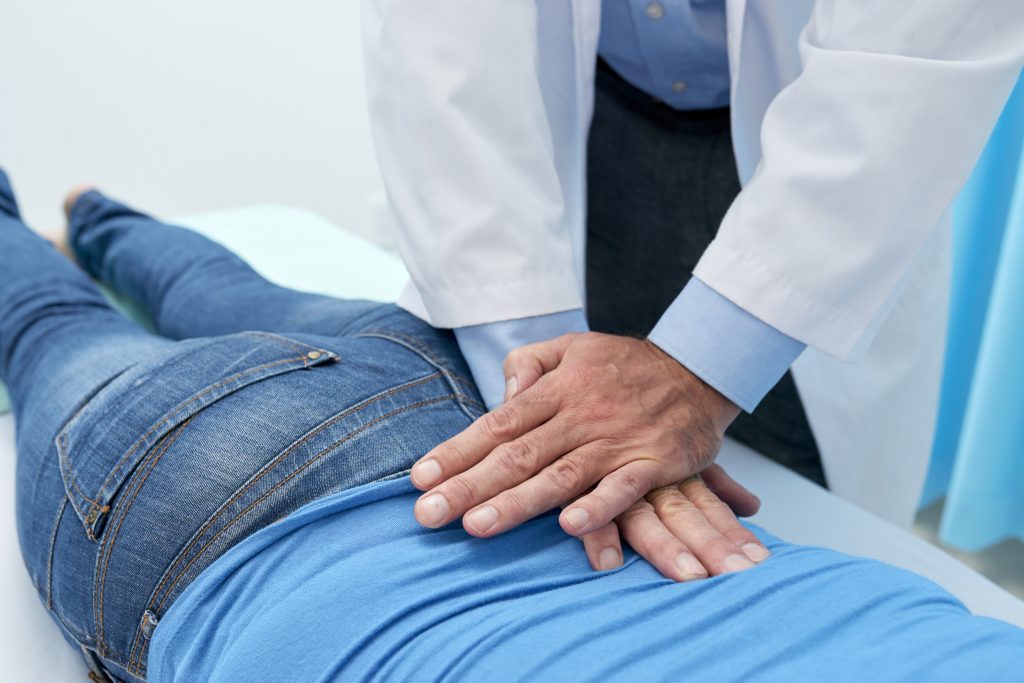 Osteopath treating the lower back